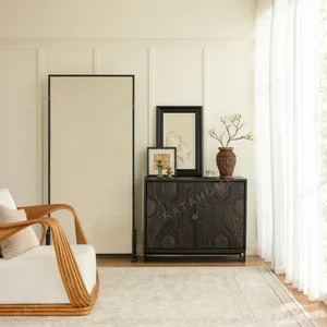 Hand-Carved Totem Door Teak Cabinet on Black Metal Base in black — in a room setting