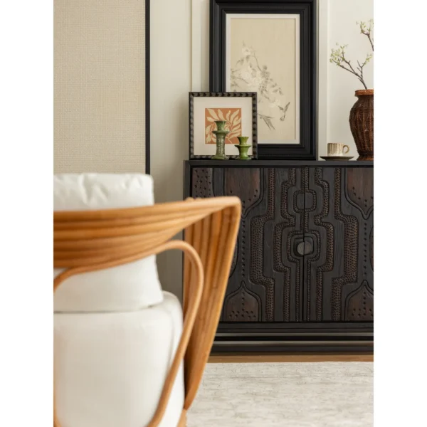 Hand-Carved Totem Door Teak Cabinet on Black Metal Base in black — in a room setting