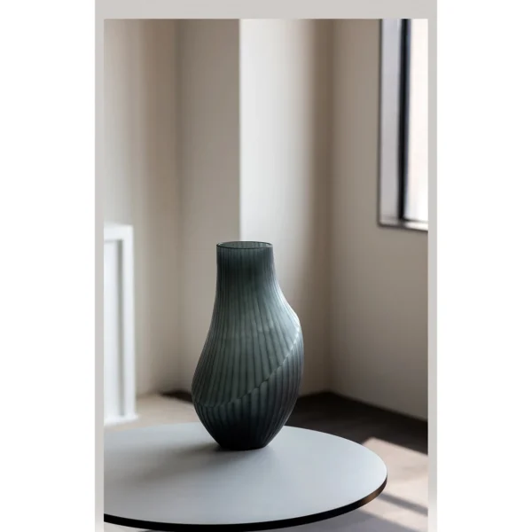 Hand-Carved Irregular Dark Green Glass Vase in olive — in a room setting