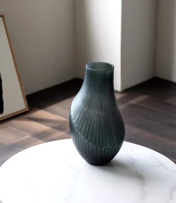 Hand-Carved Irregular Dark Green Glass Vase in olive — in a room setting
