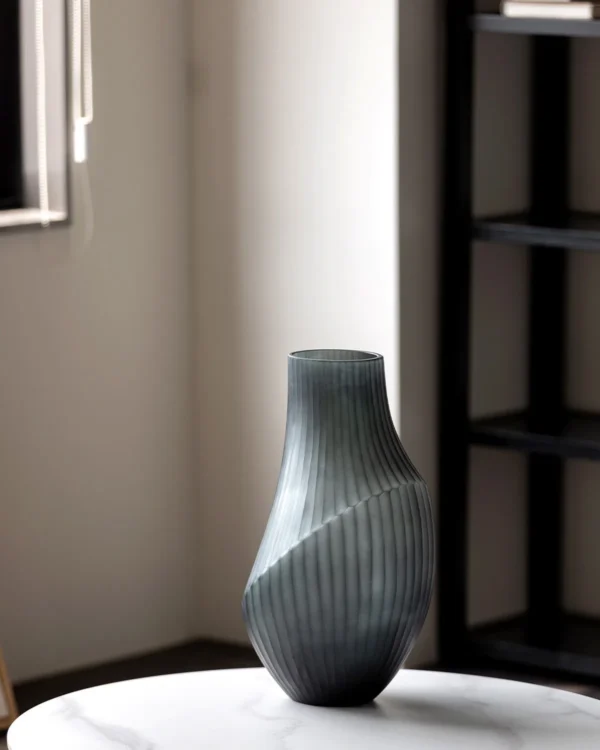 Hand-Carved Irregular Dark Green Glass Vase in olive — in a room setting