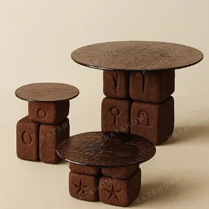 Hand-Carved Symbol Stone Block Tables in rust — in a room setting