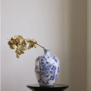 Hand-Painted Blue and White Gilded Fruit-Branch Vase in ivory — in a room setting