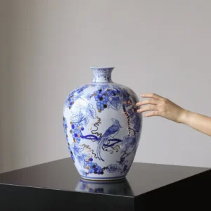 Hand-Painted Blue and White Gilded Fruit-Branch Vase in ivory — in a room setting