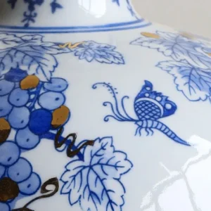 Hand-Painted Blue and White Gilded Fruit-Branch Vase in ivory — in a room setting