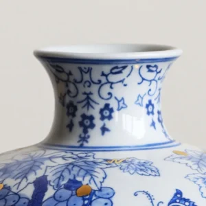 Hand-Painted Blue and White Gilded Fruit-Branch Vase in ivory — in a room setting