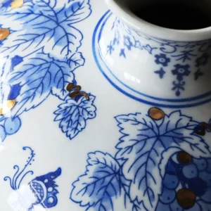 Hand-Painted Blue and White Gilded Fruit-Branch Vase in ivory — in a room setting