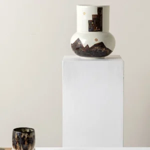 Hand-Painted Mountain Motif Cream Ceramic Vase in oatmeal — in a room setting