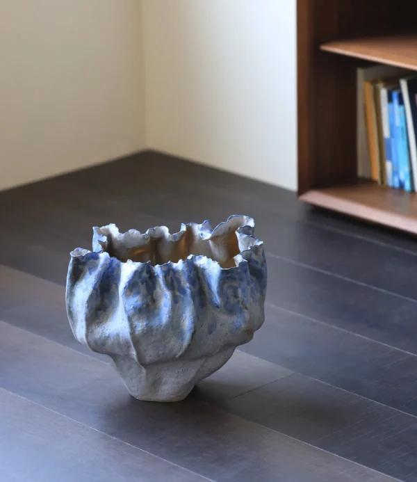 Hand-Pinched Pleated Blue-Grey Stoneware Vase in blue — in a room setting