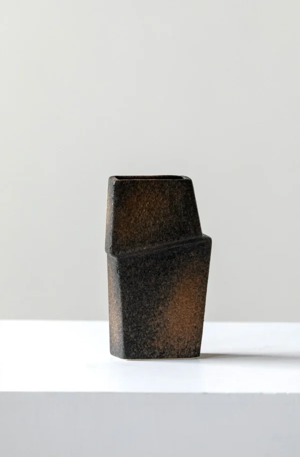 Hand-Made Offset Geometric Square Vase in Black and Rust — in a room setting