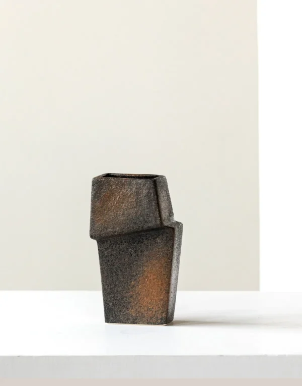 Hand-Made Offset Geometric Square Vase in Black and Rust — in a room setting