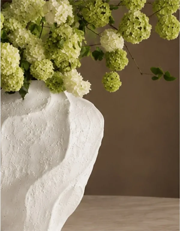 Designer Rock Texture Folded Ceramic Vase, Short in ivory — in a room setting