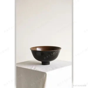 Hand-Made Two-Tone Footed Rice Bowl in Black and Rust — in a room setting