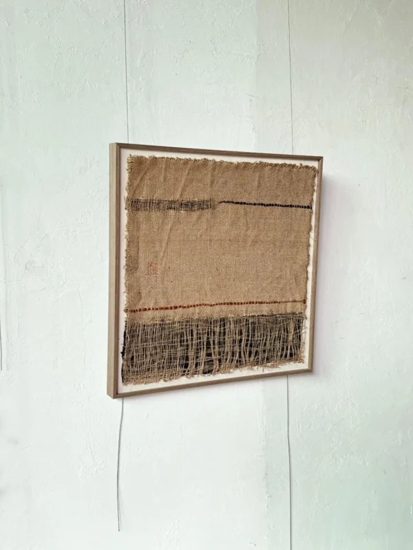 Handwoven Jute Textile Wall Art in Natural and Indigo — in a room setting