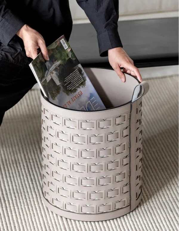 Hand-Woven Orange Leather Laundry Basket with Handles in rust — in a room setting