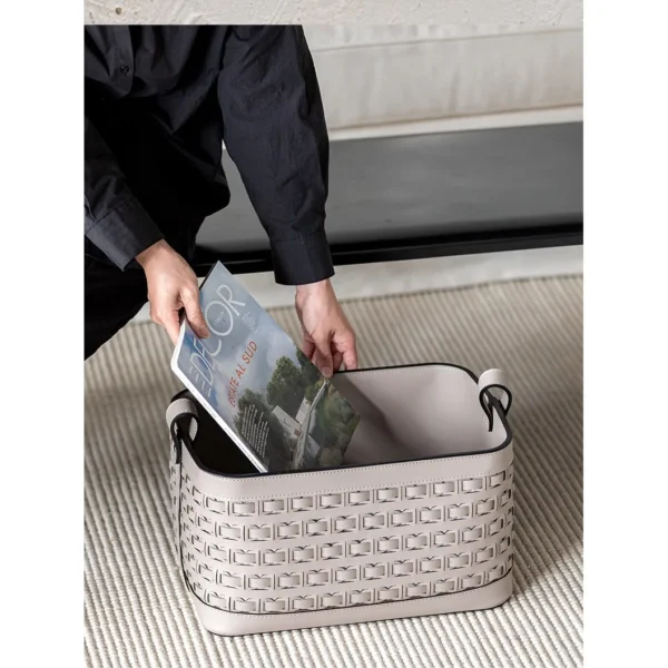Hand-Woven Taupe Leather Storage Basket with Handles in sand — in a room setting