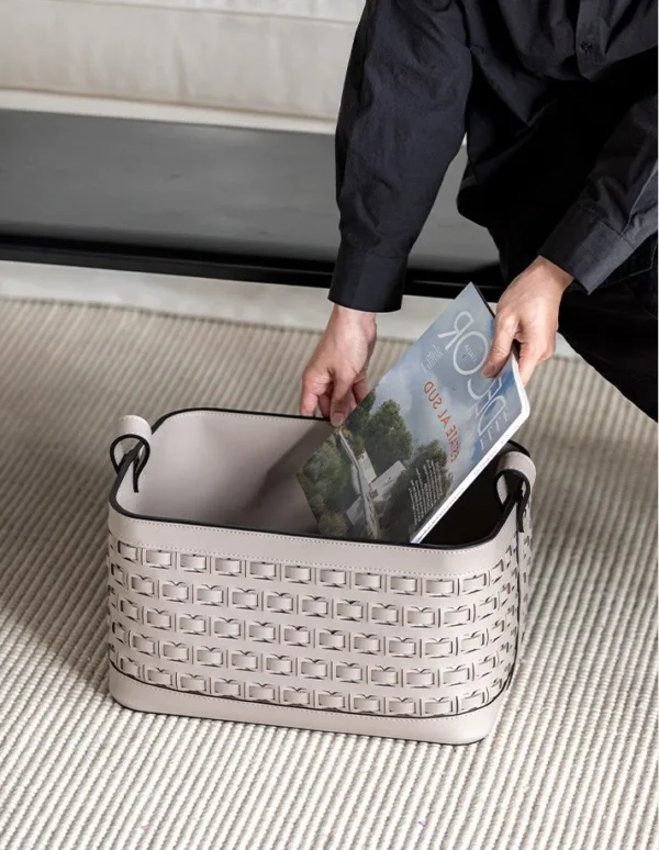 Hand-Woven Taupe Leather Storage Basket with Handles in sand — in a room setting