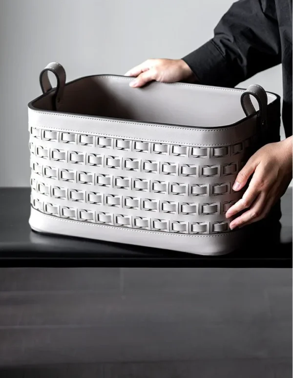 Hand-Woven Taupe Leather Storage Basket with Handles in sand — in a room setting
