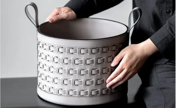 Hand-Woven Black Leather Storage Bucket with Loop Handles in black — in a room setting