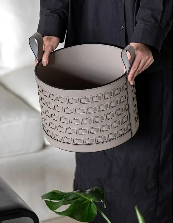 Hand-Woven Black Leather Storage Bucket with Loop Handles in black — in a room setting