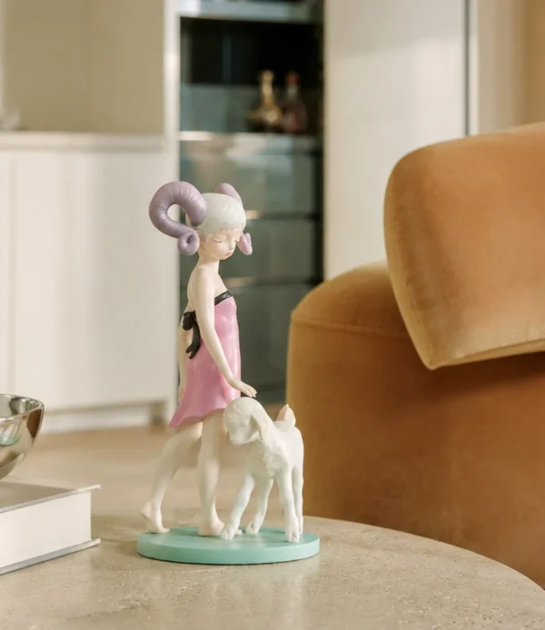 Horned Girl with Lamb Art Figurine in Resin — in a room setting
