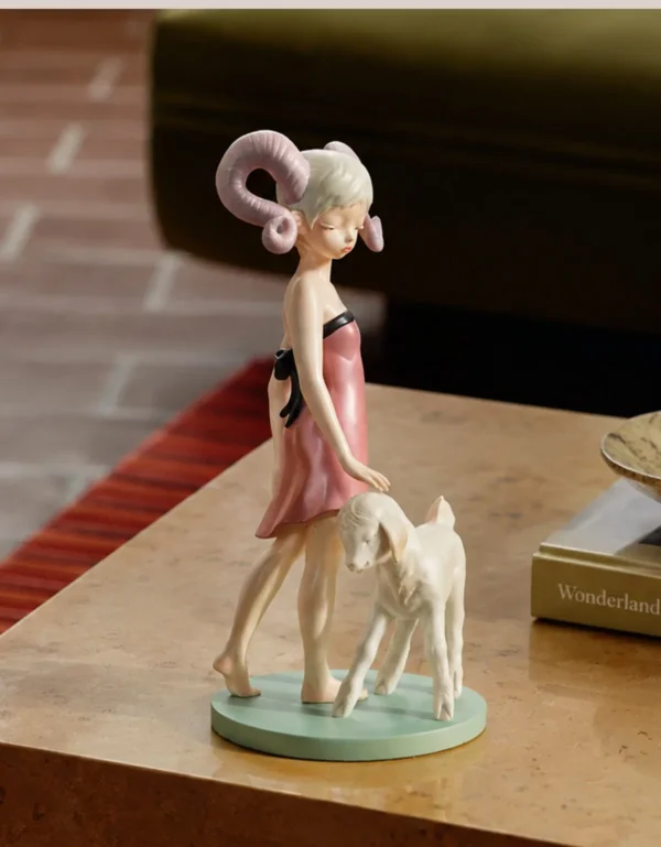 Horned Girl with Lamb Art Figurine in Resin — in a room setting