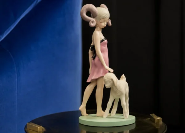 Horned Girl with Lamb Art Figurine in Resin — in a room setting