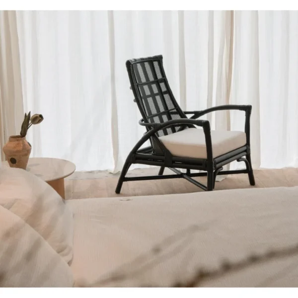 Harper Black Rattan Lounge Chair in black — in a room setting