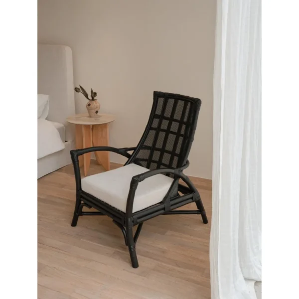 Harper Black Rattan Lounge Chair in black — in a room setting