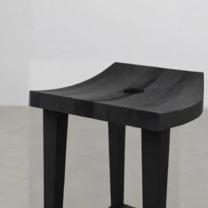 Charred Black Oak Saddle Stool in black — front view