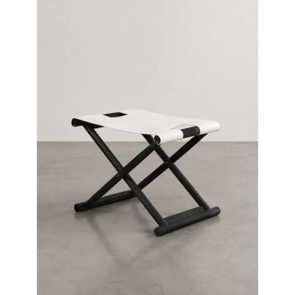 Charred Black Oak Saddle Stool in black — in a room setting