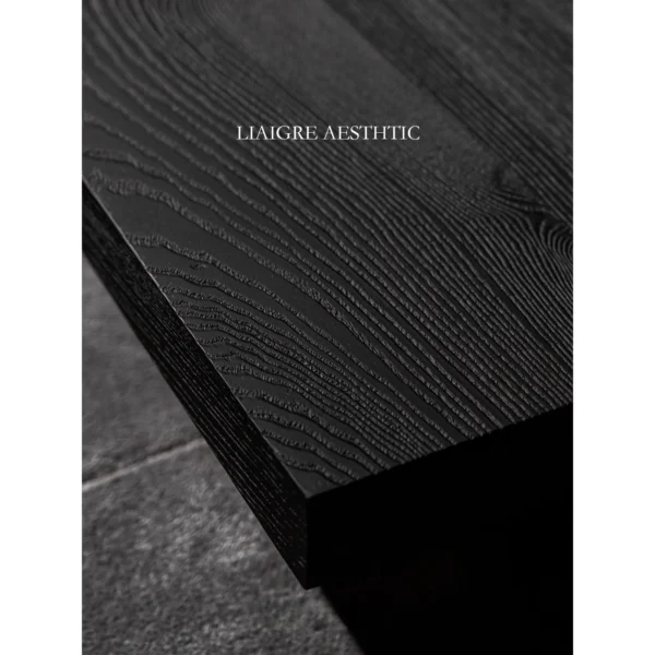 Charred Black Oak Saddle Stool in black — in a room setting