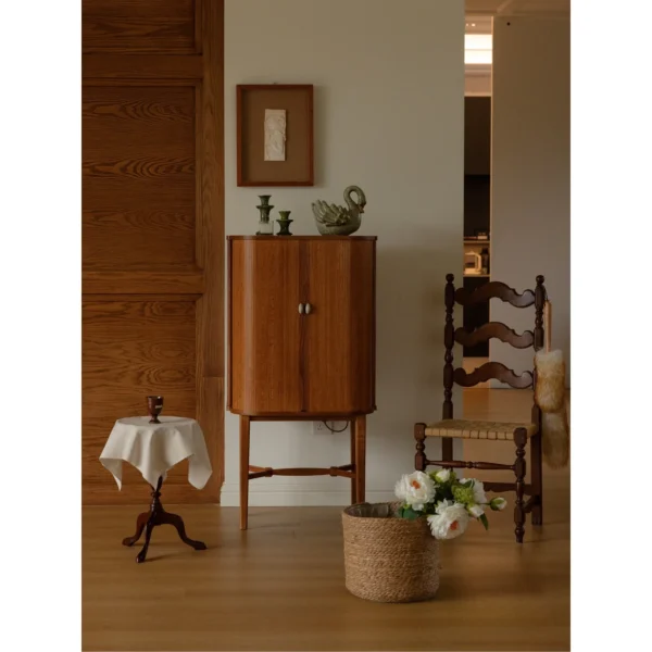 Baolu Teak Cabinet with Lit Interior and Ceramic Pulls in clay — in a room setting