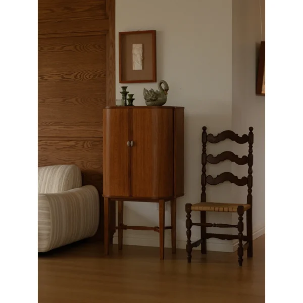 Baolu Teak Cabinet with Lit Interior and Ceramic Pulls in clay — in a room setting