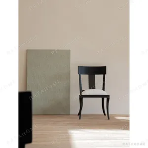 Hera Black Ash Curved-Leg Dining Chair with Linen Seat in black — in a room setting