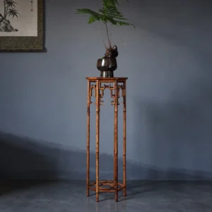 Hexagonal Bamboo Plant Stand with Key-Fret Apron in clay — front view
