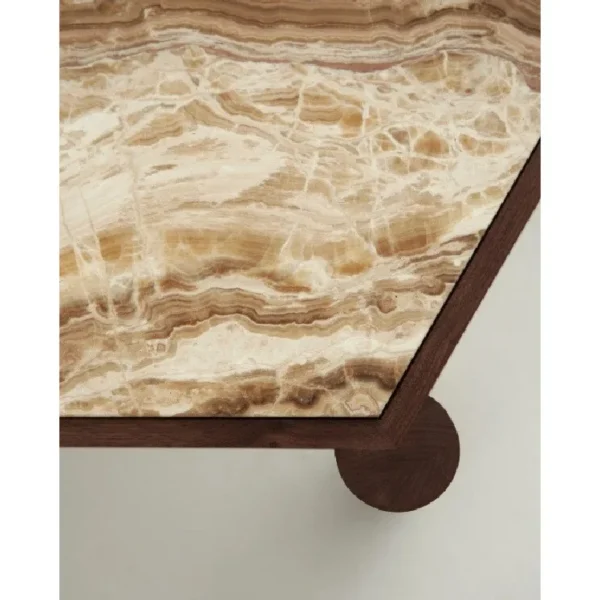 Hexagonal Travertine Coffee Table on Walnut Ball-Foot Legs in sand — in a room setting