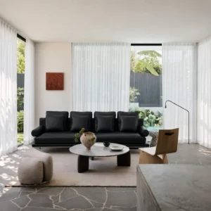 High-Leg Sofa in Black Leather with Cylinder Arms on Slim — front view