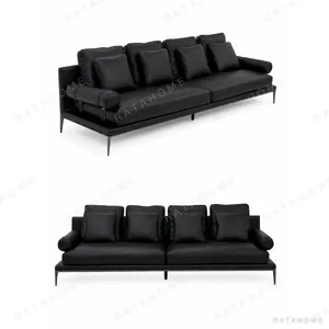 High-Leg Sofa in Black Leather with Cylinder Arms on Slim — in a room setting