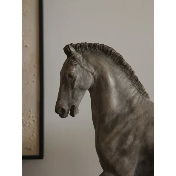Bronze-Effect Roman Horse Sculpture on Black Metal Stand in bronze — in a room setting