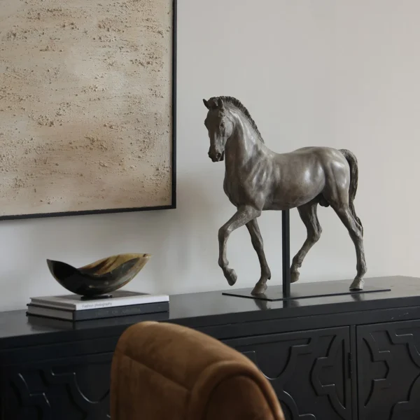 Bronze-Effect Roman Horse Sculpture on Black Metal Stand in bronze — in a room setting