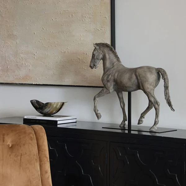 Bronze-Effect Roman Horse Sculpture on Black Metal Stand in bronze — in a room setting