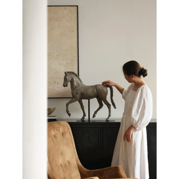 Bronze-Effect Roman Horse Sculpture on Black Metal Stand in bronze — in a room setting