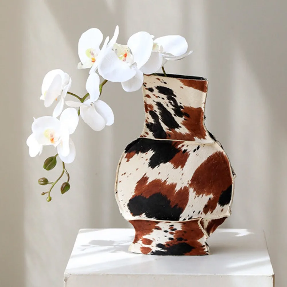 Cowhide-Wrapped Ceramic Vase in Black and Brown Spots — front view