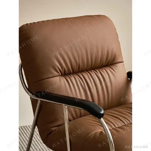 S-Curve Lounge Chair in Cognac Leather on Steel Frame — in a room setting