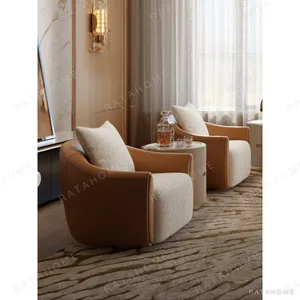 Carson Tan Leather and Cream Bouclé Lounge Chair in clay — in a room setting