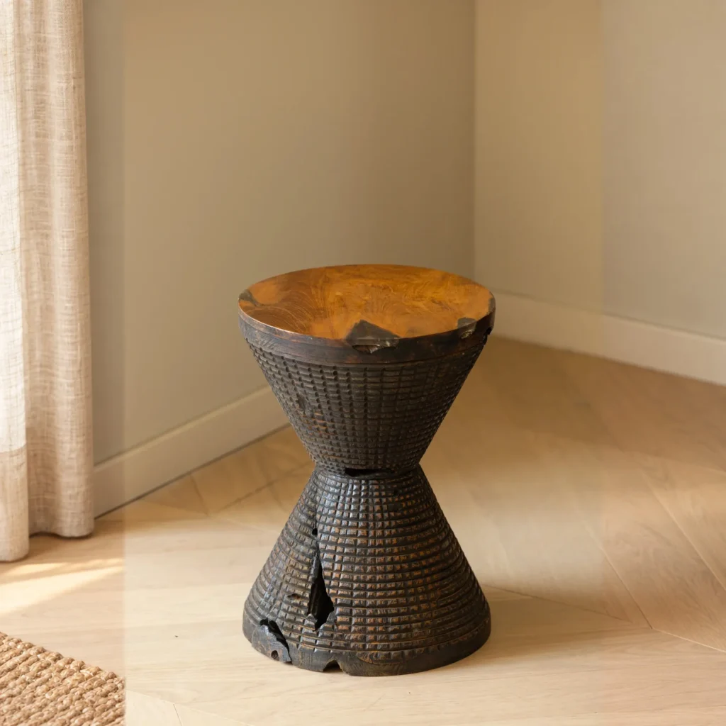 Hourglass Carved Teak Stool with Natural Hollows in clay — front view