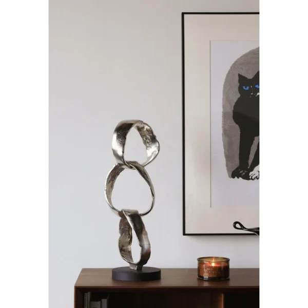 Imported Aluminium Ring Sculptures on Black Base, Two Forms in silver — in a room setting