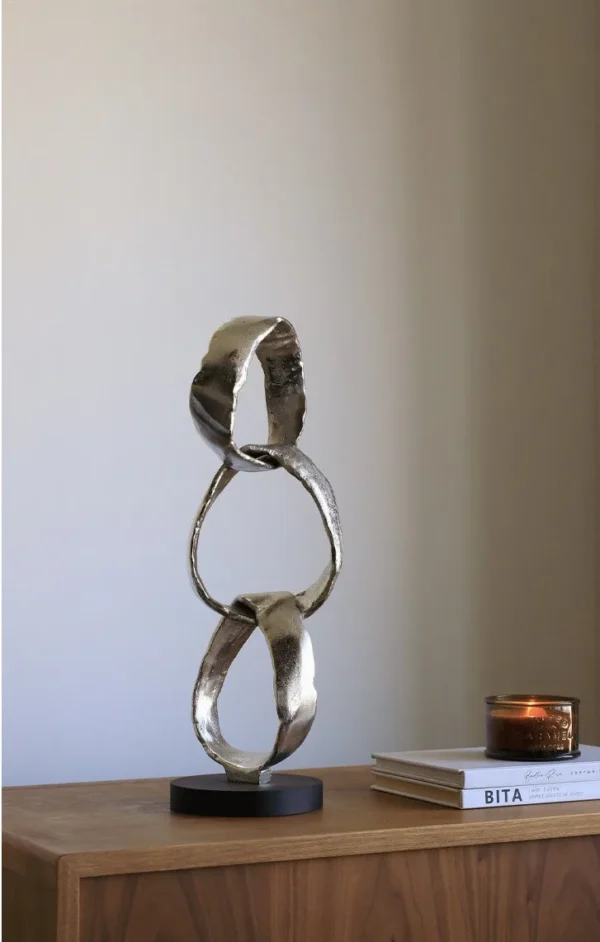 Imported Aluminium Ring Sculptures on Black Base, Two Forms in silver — in a room setting