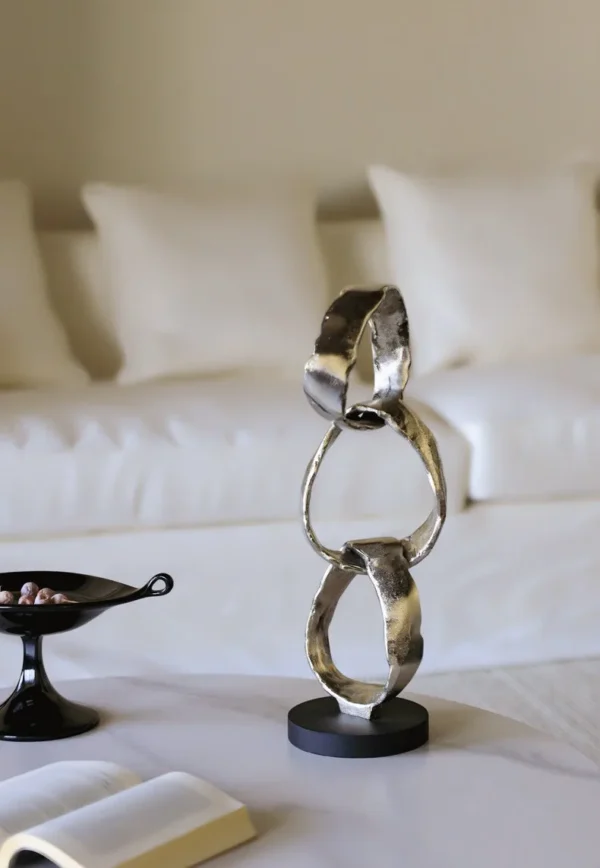 Imported Aluminium Ring Sculptures on Black Base, Two Forms in silver — in a room setting